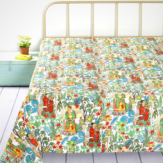 Colorful hand-stitched Kantha blanket featuring Frida Kahlo design on a bed with brass headboard, lightweight cotton quilt for year-round use.