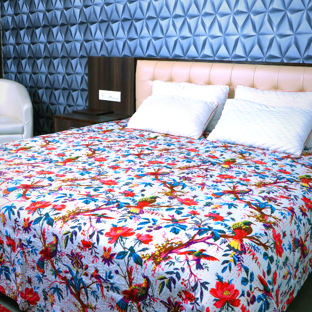 Colorful Kantha Blanket with Bird of Paradise quilted design on bed in modern bedroom setting