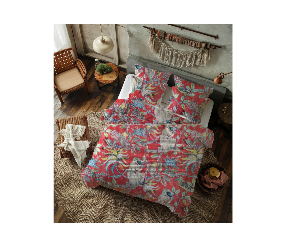 Colorful cotton Kantha blanket with monkey print on bed in rustic bedroom setting