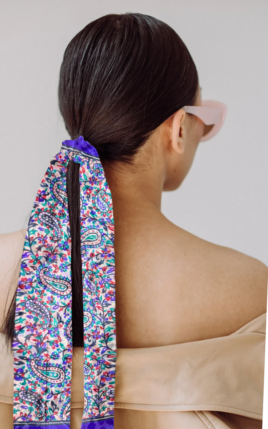 luxurious hand-hemmed silk scarf in bright colors styled in hair