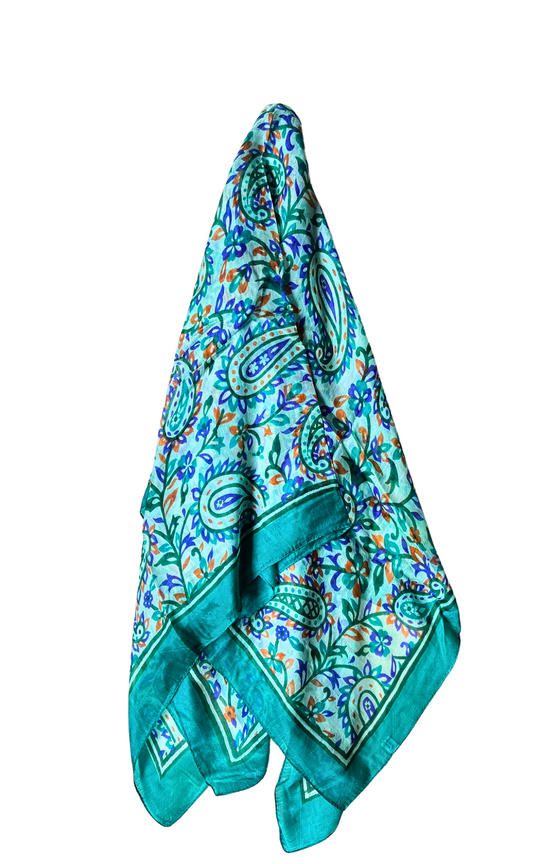 Lightweight hand-hemmed silk scarf in vibrant blue and green paisley pattern, luxurious and breathable accessory
