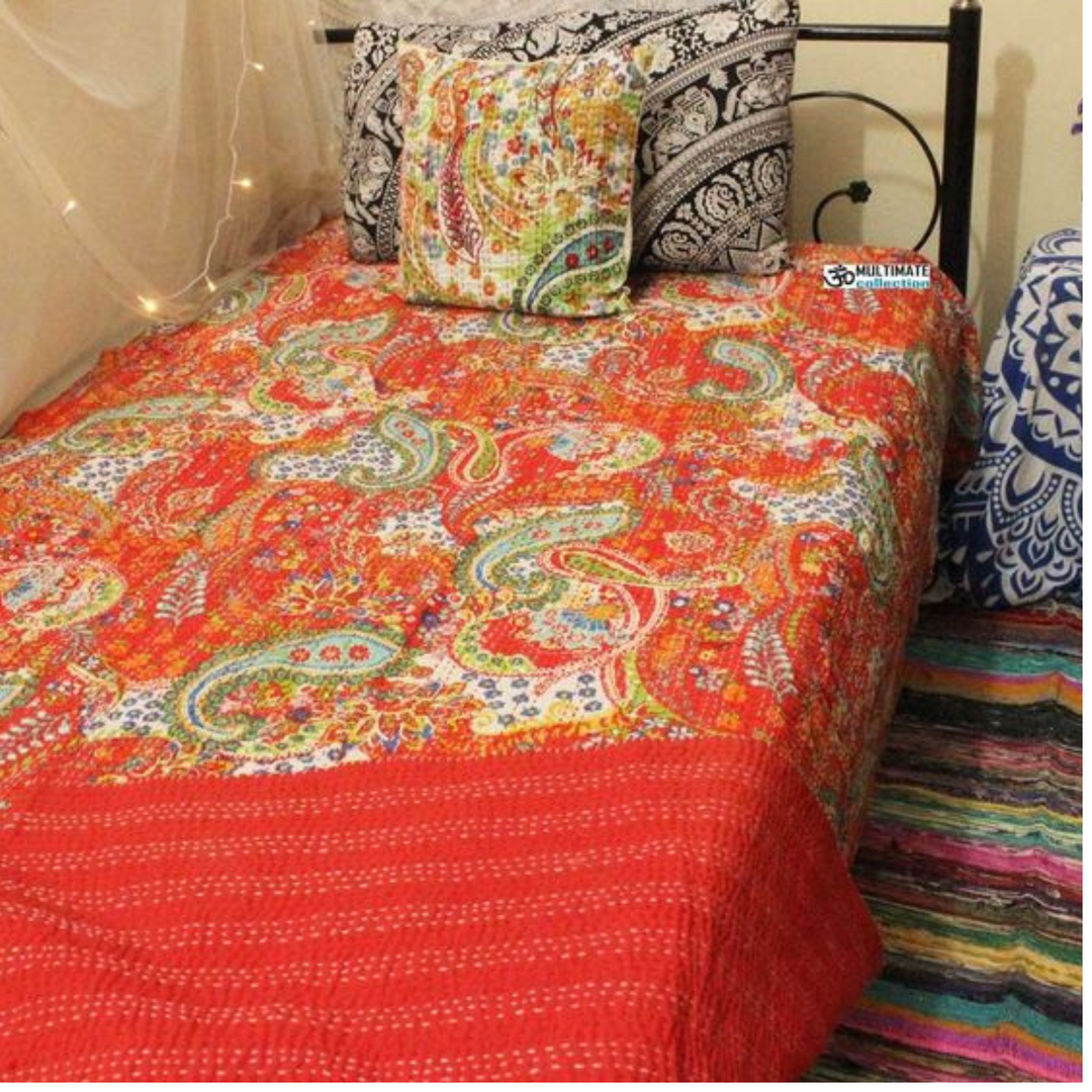 Colorful paisley patterned Kantha blanket set with quilt and pillowcase on bed, handmade cotton textile with traditional embroidery.