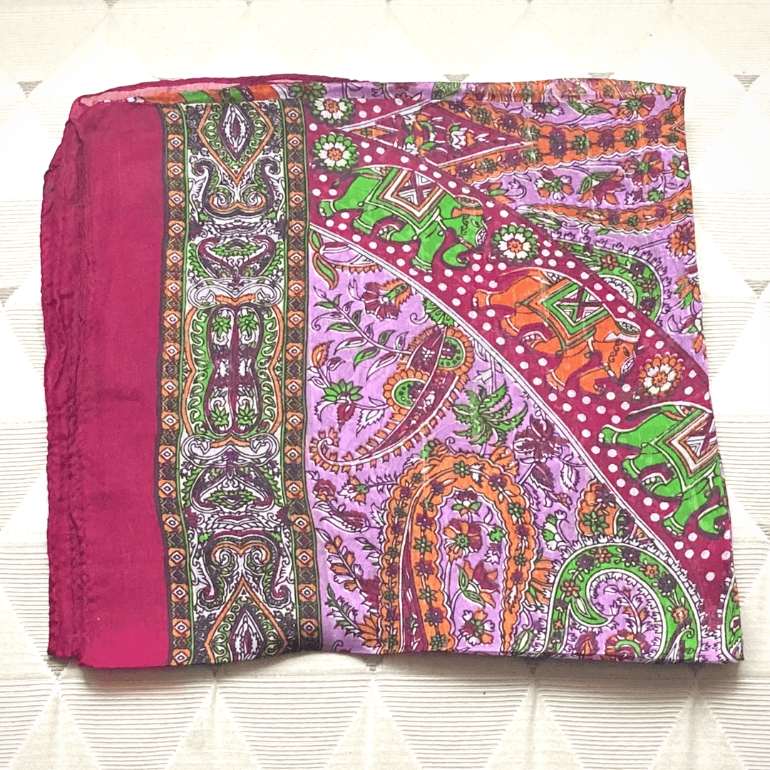 Vibrant hand-hemmed lightweight silk scarf with intricate paisley and elephant patterns in bright colors