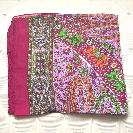 Vibrant hand-hemmed lightweight silk scarf with intricate paisley and elephant patterns in bright colors