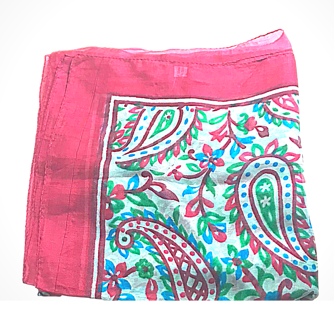 Lightweight hand-hemmed silk scarf with vibrant paisley and floral patterns in pink, green, and blue hues