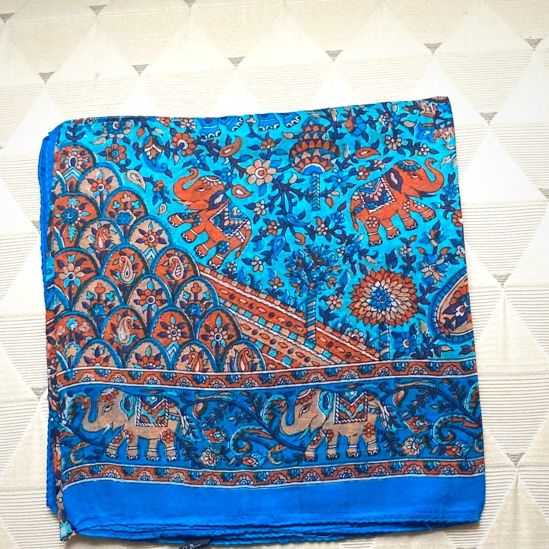 Blue lightweight silk scarf with hand-hemmed edges and intricate elephant and floral patterns