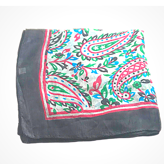 Lightweight hand-hemmed silk scarf with bright paisley and floral patterns in vibrant colors including red, green, blue, and black border