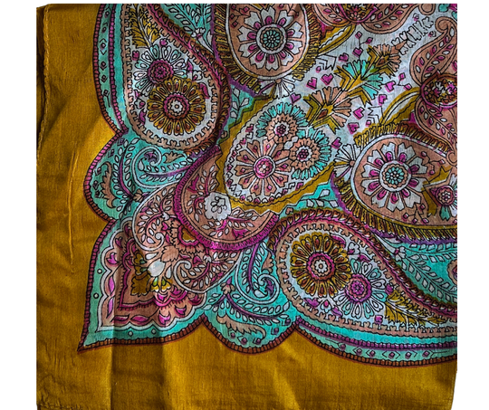 Hand-hemmed lightweight silk scarf with vibrant paisley pattern in mustard, teal, pink, and gold tones