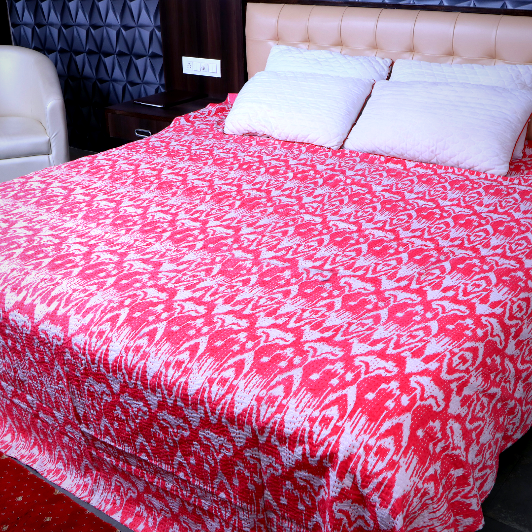 Red and white ikat design Kantha blanket on bed with pillows, handmade quilt set, lightweight cotton bedspread